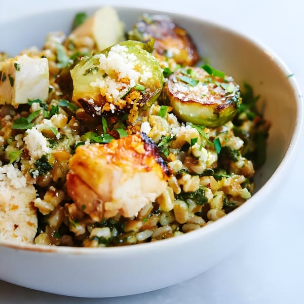 Close-up of Porano's Italian farro bowl with roasted Brussels sprouts, chicken, and parmesan cheese.